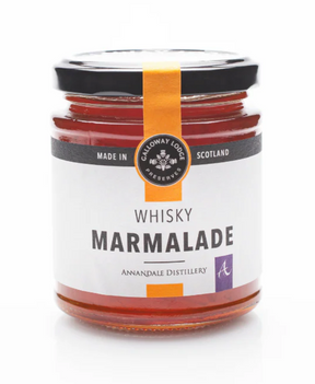 A glass jar of Whisky Marmalade with an orange label and black lid. The label reads "Made in Scotland" and "Annandale Distillery," showcasing its Scottish whisky marmalade heritage.