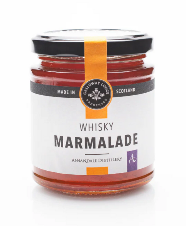A glass jar of Whisky Marmalade with an orange label and black lid. The label reads "Made in Scotland" and "Annandale Distillery," showcasing its Scottish whisky marmalade heritage.