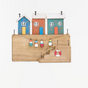 Batela colourful wooden harbour houses decoration with miniature buoys and lifebuoys.