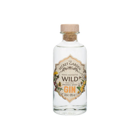 A clear glass bottle of Midi Wild Gin Made with Organic Spirit from Secret Garden Distillery, featuring a floral label and cork stopper. This handcrafted Scottish gin (39% vol) uses organic spirit and wild botanicals for a unique taste.