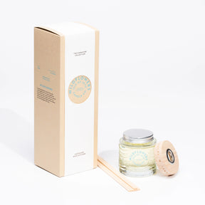 The Wildflower Reed Diffuser from Isle of Skye Candle Company includes a beige box, glass jar labeled "Wildflowers," light wood cap, and reed sticks—an elegant way to infuse your space with a delicate floral scent.