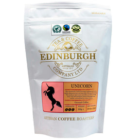 A 200g white bag of Unicorn Coffee Blend from Edinburgh Tea & Coffee Company, featuring gold and black text, a unicorn silhouette, certification logos at the top, and artisan Scottish-roasted coffee inside.