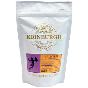 A 200g resealable white bag of Valkyrie Breakfast Coffee from the Edinburgh Tea & Coffee Company, featuring an orange and purple design with a valkyrie silhouette. This artisan Scottish coffee, included in The Arran Gift Box, is small batch roasted to strength 5 for a bold flavor.
