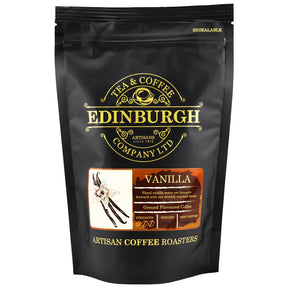 A black resealable bag of Vanilla Ground Coffee 200 g by Edinburgh Tea & Coffee Company, with gold and white text, a vanilla flower illustration, and labels for strength and small-batch roasted premium Scottish coffee.