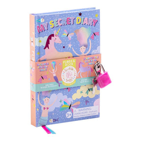 A pastel-colored “Fantasy My Scented Secret Diary” featuring unicorn and fairy illustrations, a pink padlock, and a label indicating it is scented and suitable for ages 3+, with a warning about small parts.