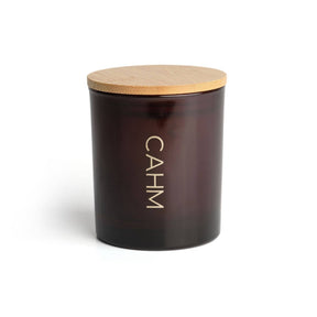 A dark brown glass Atacama Soy Wax Candle with a light wooden lid. "CAHM" is printed vertically in white on the front, set against a plain white background—perfect for highlighting its luxury soy blend and subtle summer fragrance.