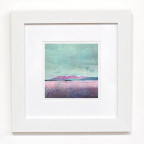 The Isle of Arran Giclee Prints: No / Mini-print showcases a pastel landscape with pinkish mountains, calm water, and a cloudy sky, available as limited edition prints in a white mat and frame.