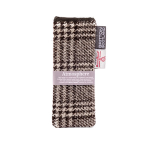 The "Atmosphere" Harris Tweed Glasses Pouch features a handmade black and white houndstooth design from sustainable Harris Tweed in Scotland, lined with natural cotton and lavender for soothing comfort.