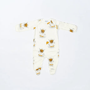 The Highland Cow Baby Sleepsuit is a cream-colored, long-sleeve sleepsuit featuring playful brown and orange highland cow cartoons. Eco-friendly and cozy, it’s perfect for keeping your baby comfortable.