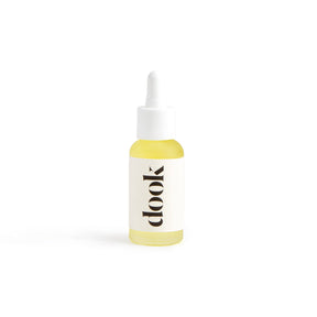 A small glass dropper bottle filled with yellow liquid, labeled "Leave-in Conditioning Oil," stands upright on a white background—ideal for natural hair care or as an organic argan oil leave-in conditioner.