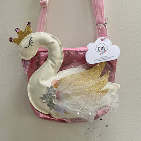The Children's Swan Bag is a cute pink purse with a plush white swan, gold crown, glittery tulle feathers, decorative seashells, and a "Bella & Boo" tag—ideal as a charming gift bag for special occasions.