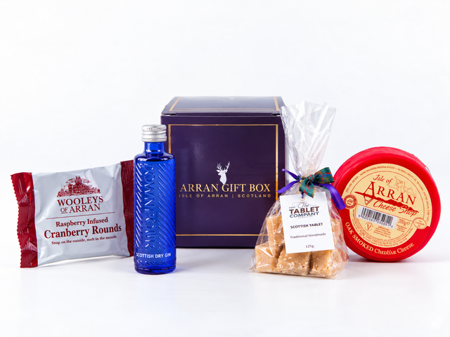 A Wee Scottish Gin Lover Gift Box – 5cl containing a miniature bottle of Downpour Scottish Dry Gin, a pack of raspberry cranberry rounds, a bag of Scottish tablet, and a round of oak-smoked cheddar cheese.