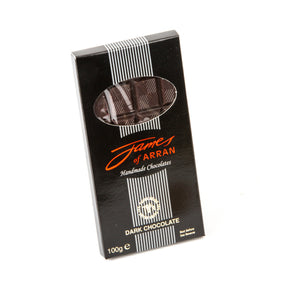 A rectangular black box of "James Chocolates Luxury bar of Plain Chocolate," specifically a 70% dark chocolate bar, features a small window revealing the rich chocolate inside. The box prominently showcases elegant white and red text with vertical stripes on the front and indicates a weight of 100g.